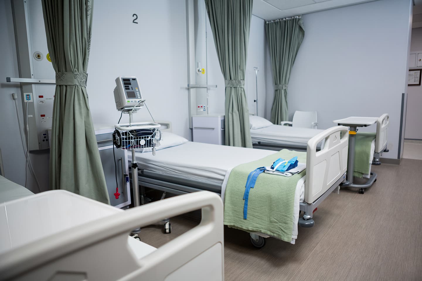 Rows of hospital beds in a ward